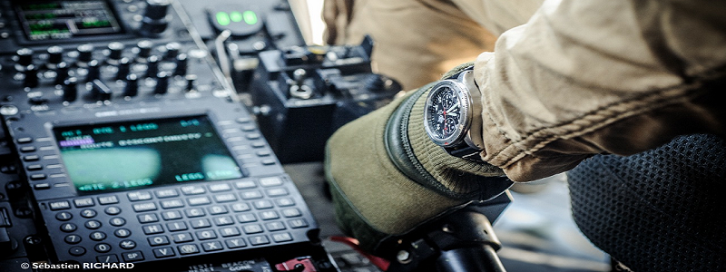 Pilot in cockpit wearing a T.O.T TIME ON TARGET